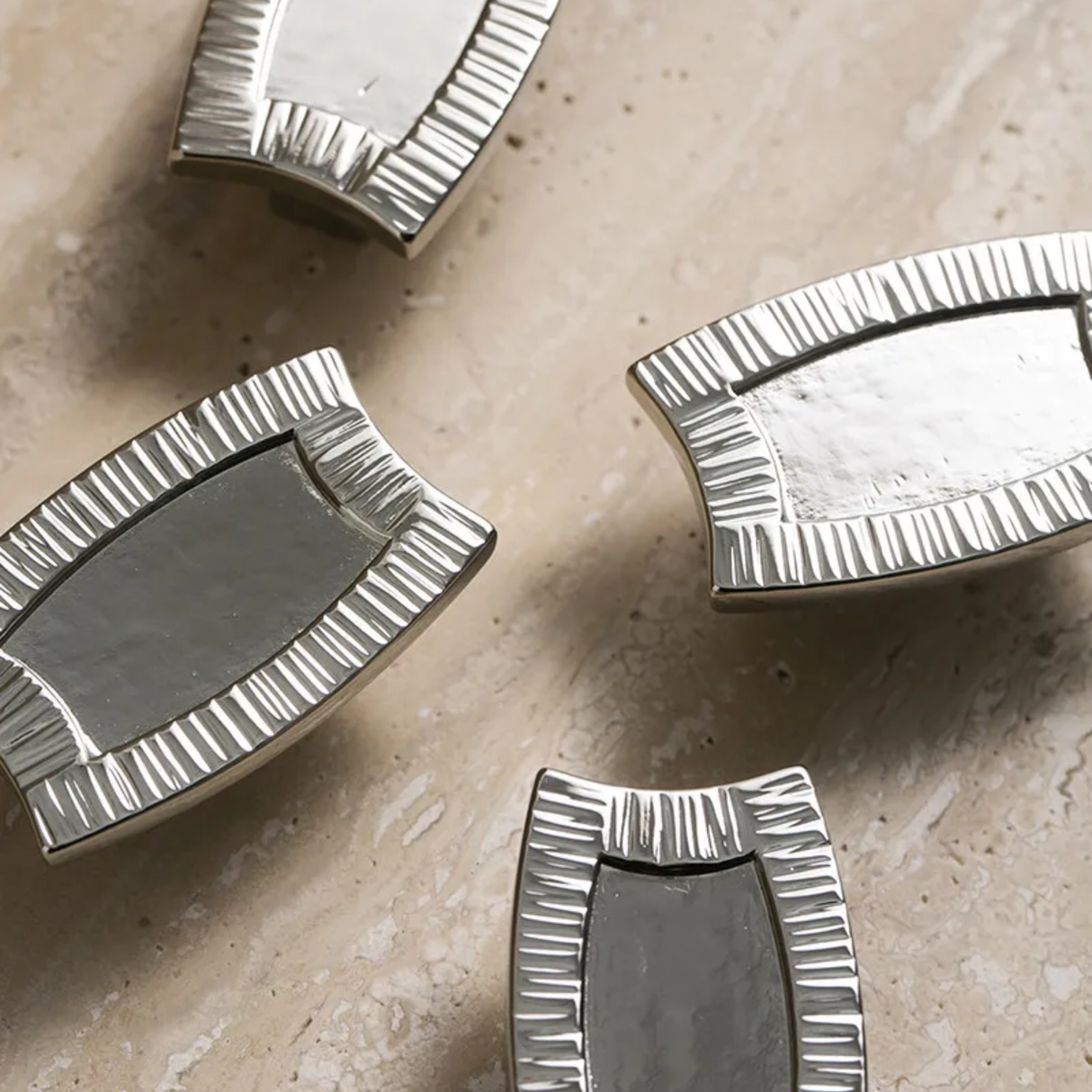 Silver decorative elements on a beige surface