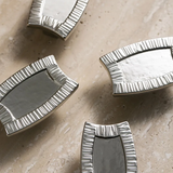 Silver decorative elements on a beige surface