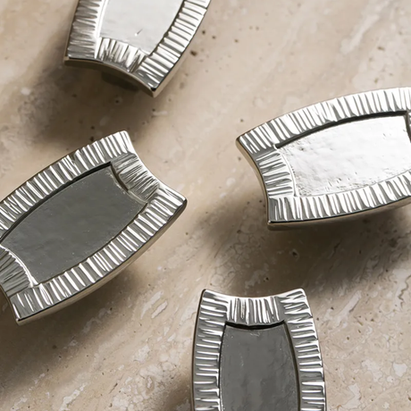 Silver decorative elements on a beige surface