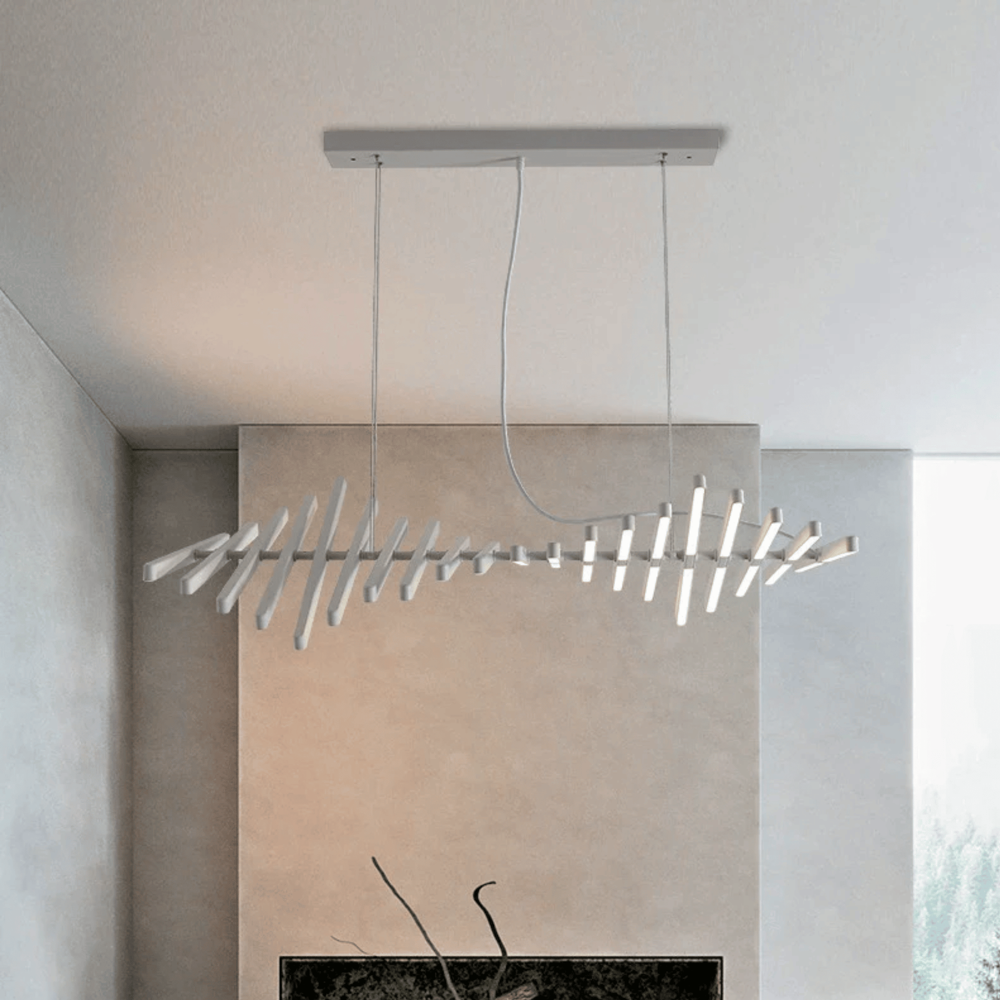 Modern pendant light fixture hanging in a room with neutral walls.