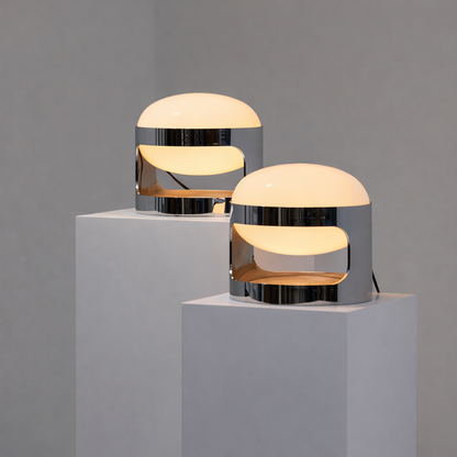 Two modern table lamps on gray pedestals against a gray background