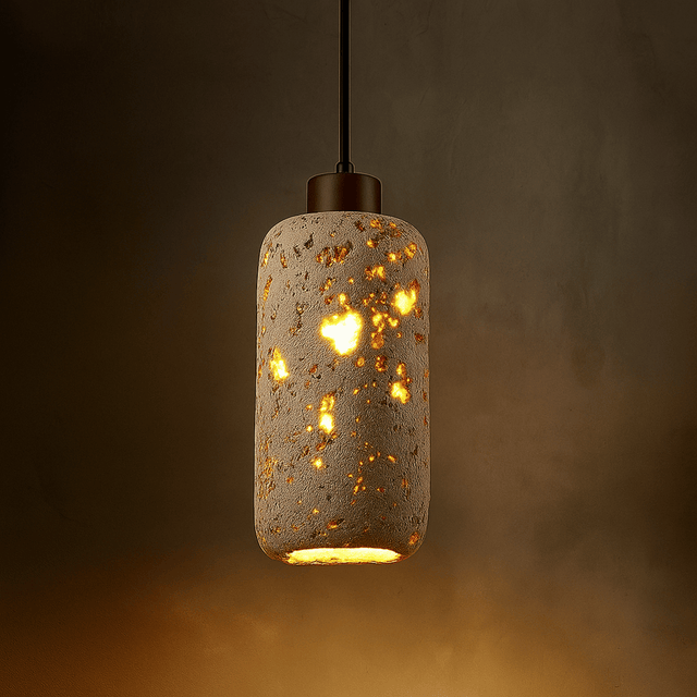 Decorative pendant light with a textured concrete-like finish on a dark background