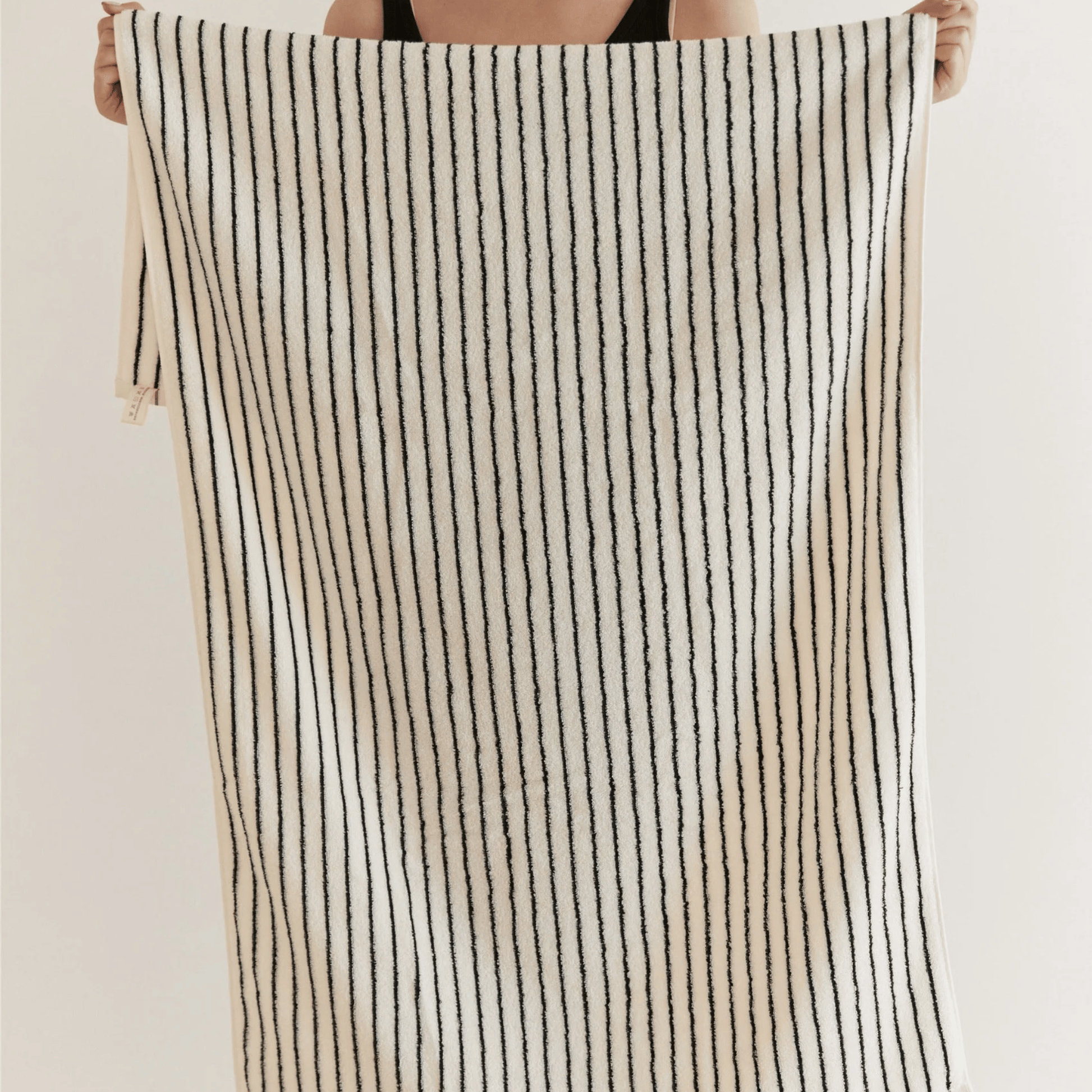 Someone holding a Striped Black & White Towel