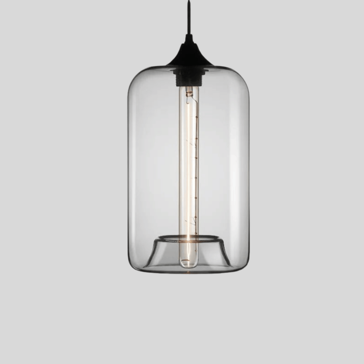 Clear glass pendant light with black fixture on a gray background