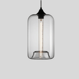 Clear glass pendant light with black fixture on a gray background
