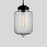Clear glass pendant light with black fixture on a gray background