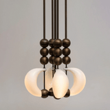 Modern chandelier with glass shades and metal accents on a gray background