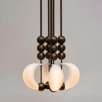 Modern chandelier with glass shades and metal accents on a gray background