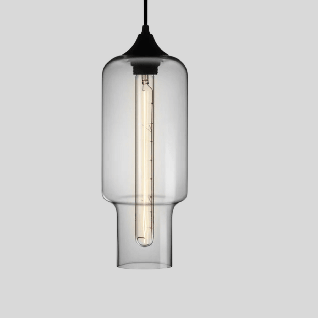 Clear glass pendant light with black fixture on a gray background