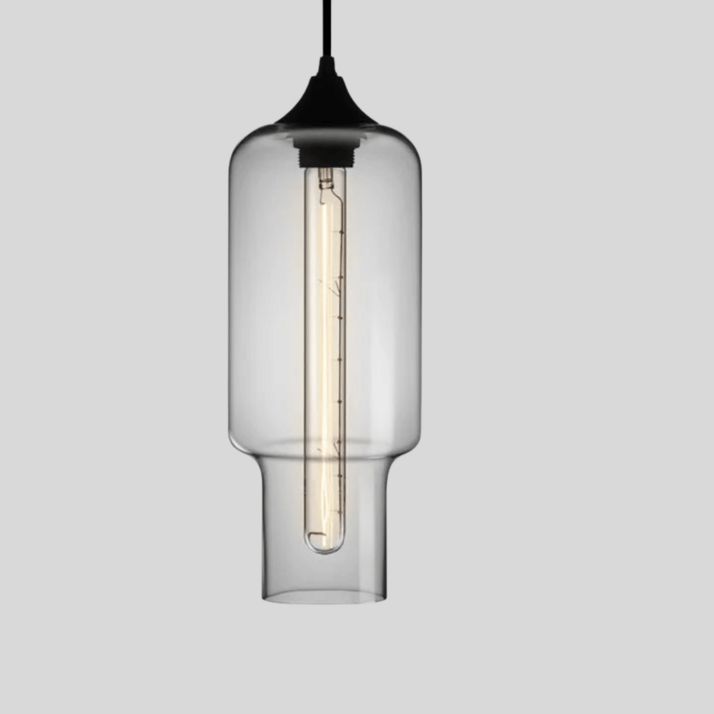 Clear glass pendant light with black fixture on a gray background