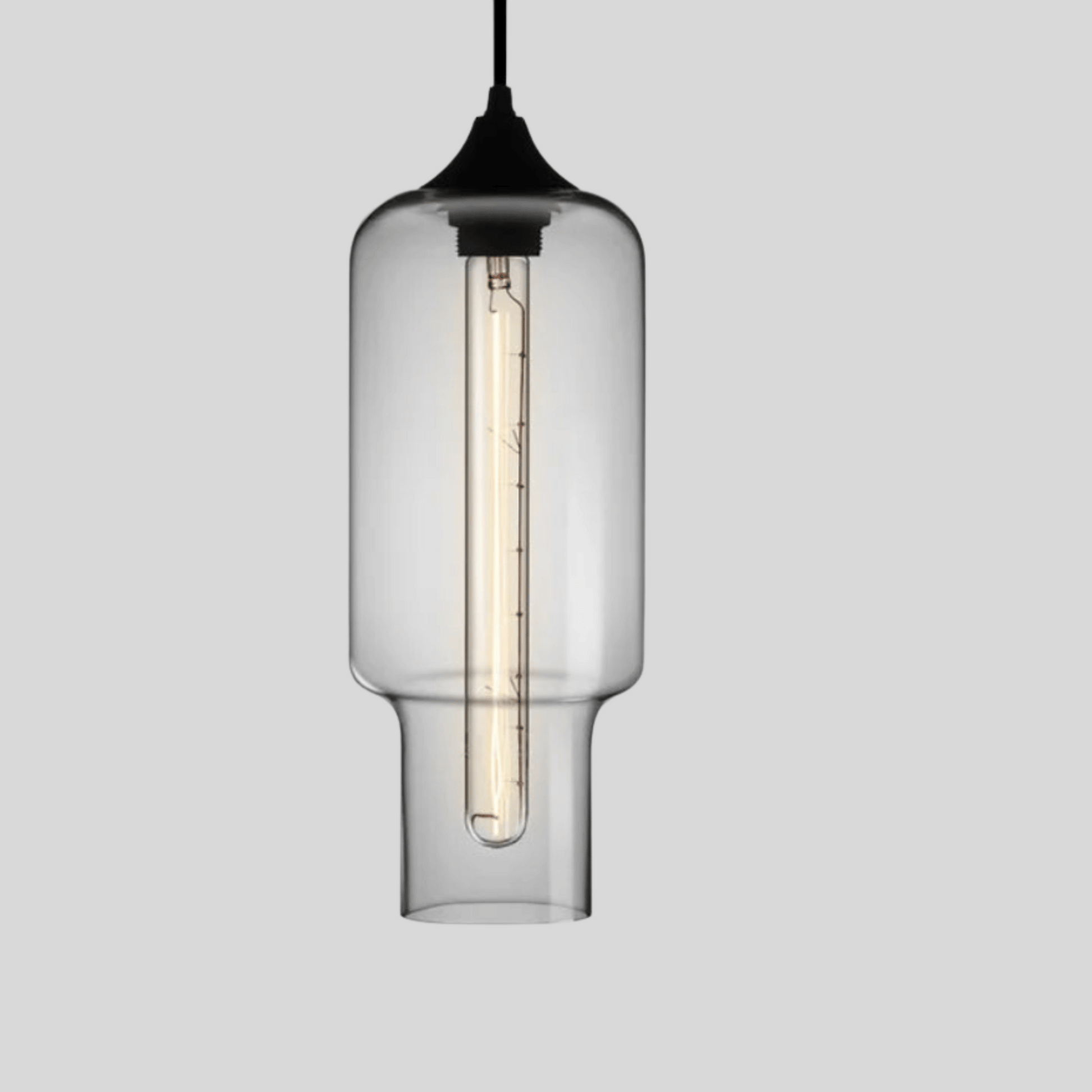 Clear glass pendant light with black fixture on a gray background