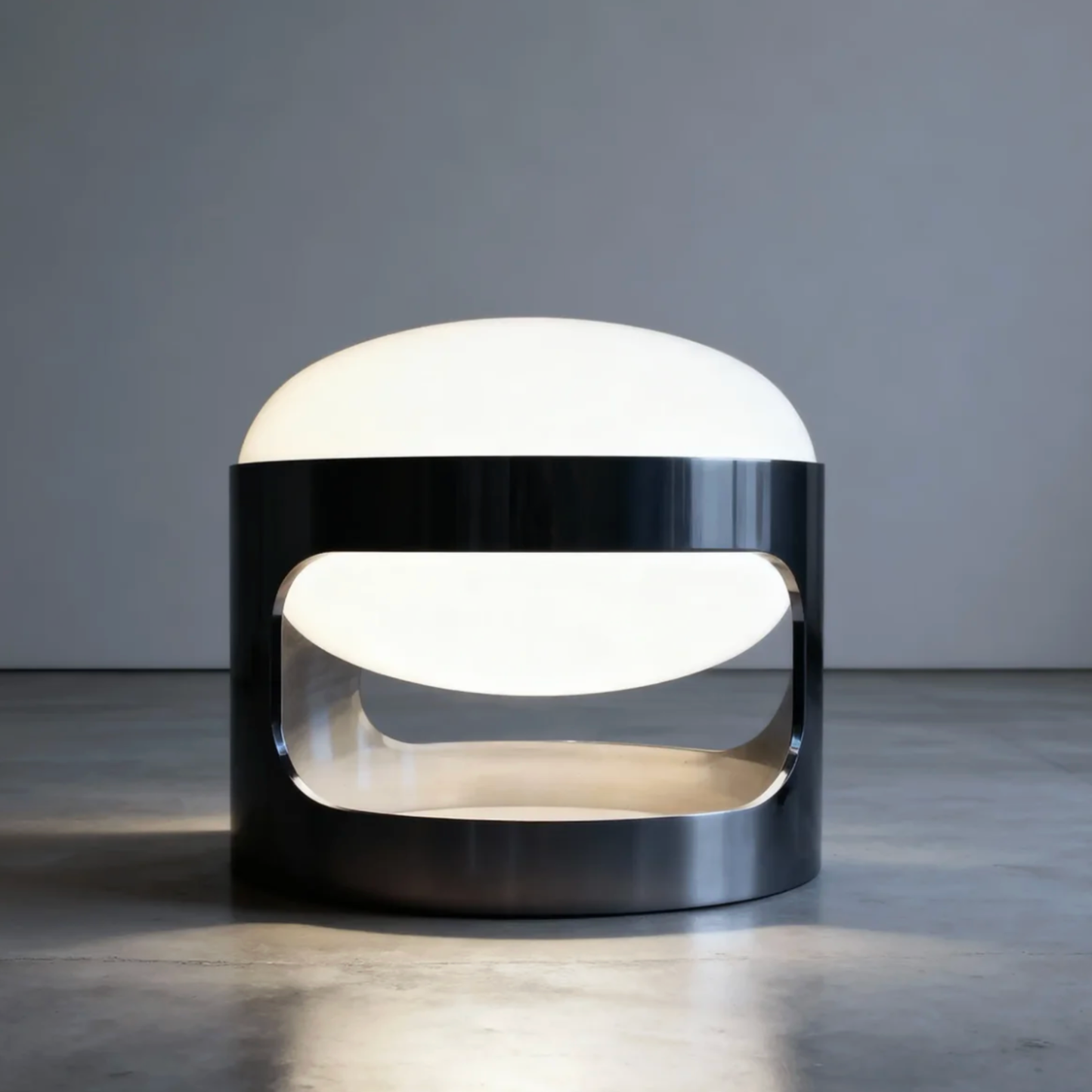 Modern table lamp with a black base and white shade on a gray surface.
