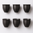 Six black ceramic cups arranged in two rows on a white background