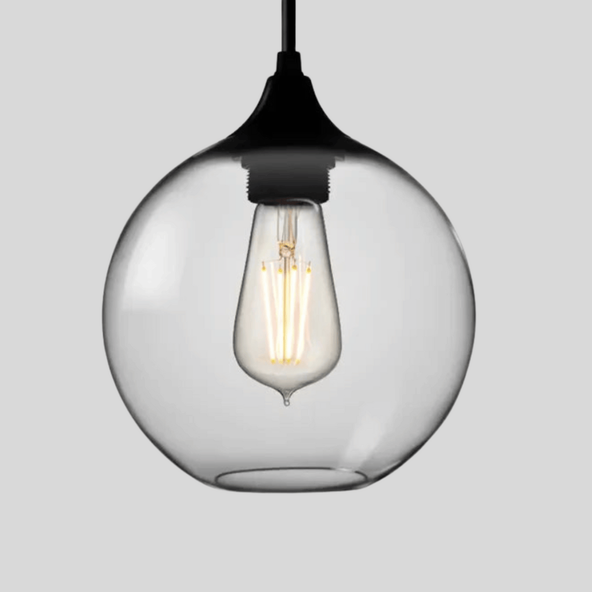 Clear glass pendant light with a black fixture on a gray background