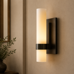 Wall-mounted light fixture with a warm glow on a beige wall.