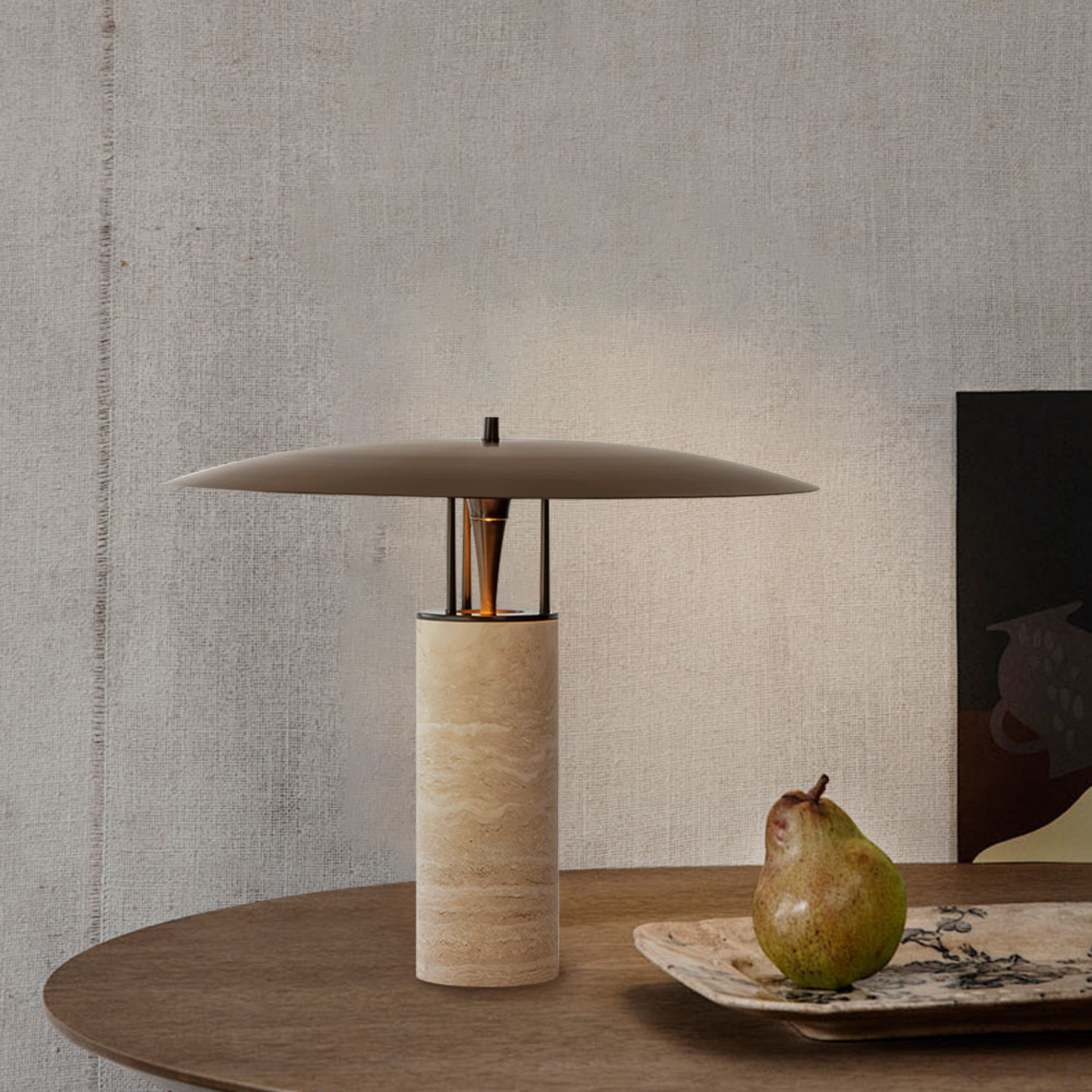 Minimal wooden table featuring a bamboo lamp and a decorative pear under natural light