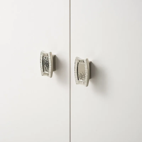 Pair of silver earrings on a light gray background