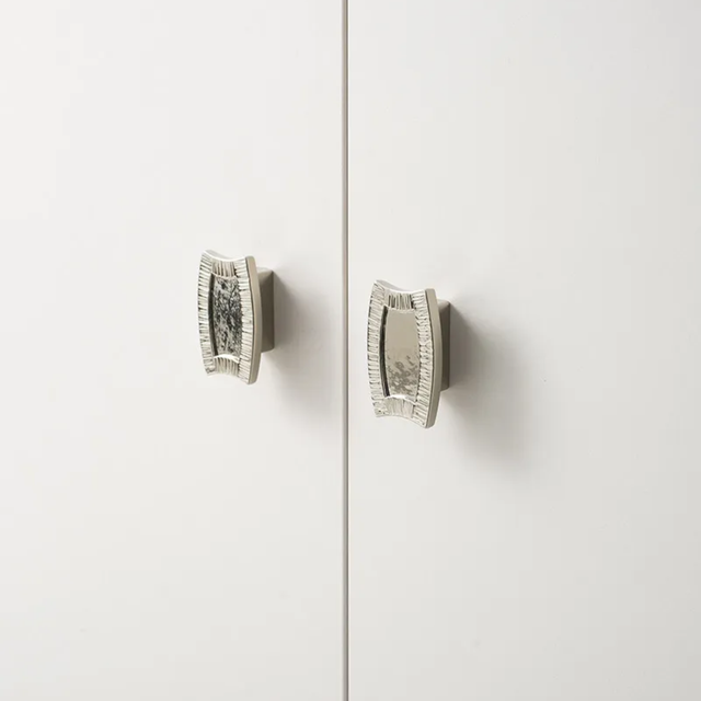 Pair of silver earrings on a light gray background