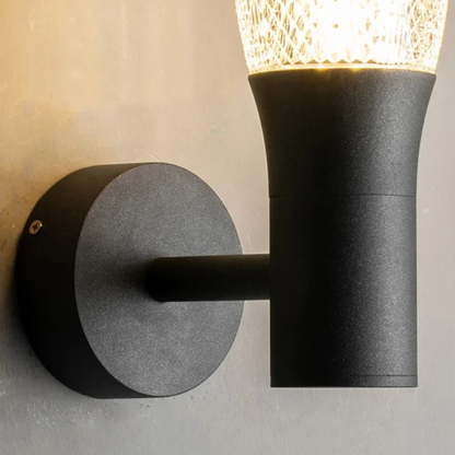 Minimalist matte black outdoor wall fixture with frosted glass shade and elegant curved mount