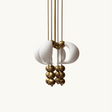 Chandelier with white ceramic balls and gold metal accents on a white background