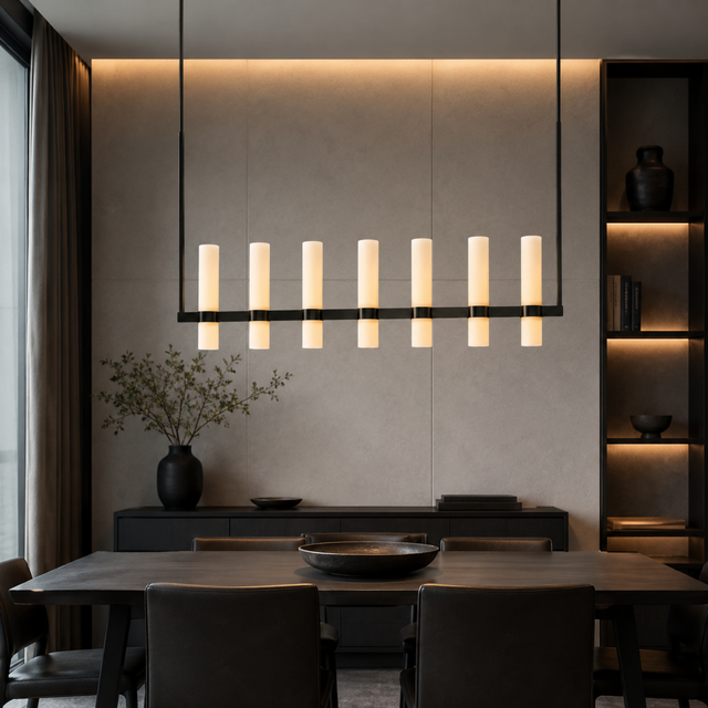 Modern dining room with a long pendant light fixture, wooden table, and chairs.
