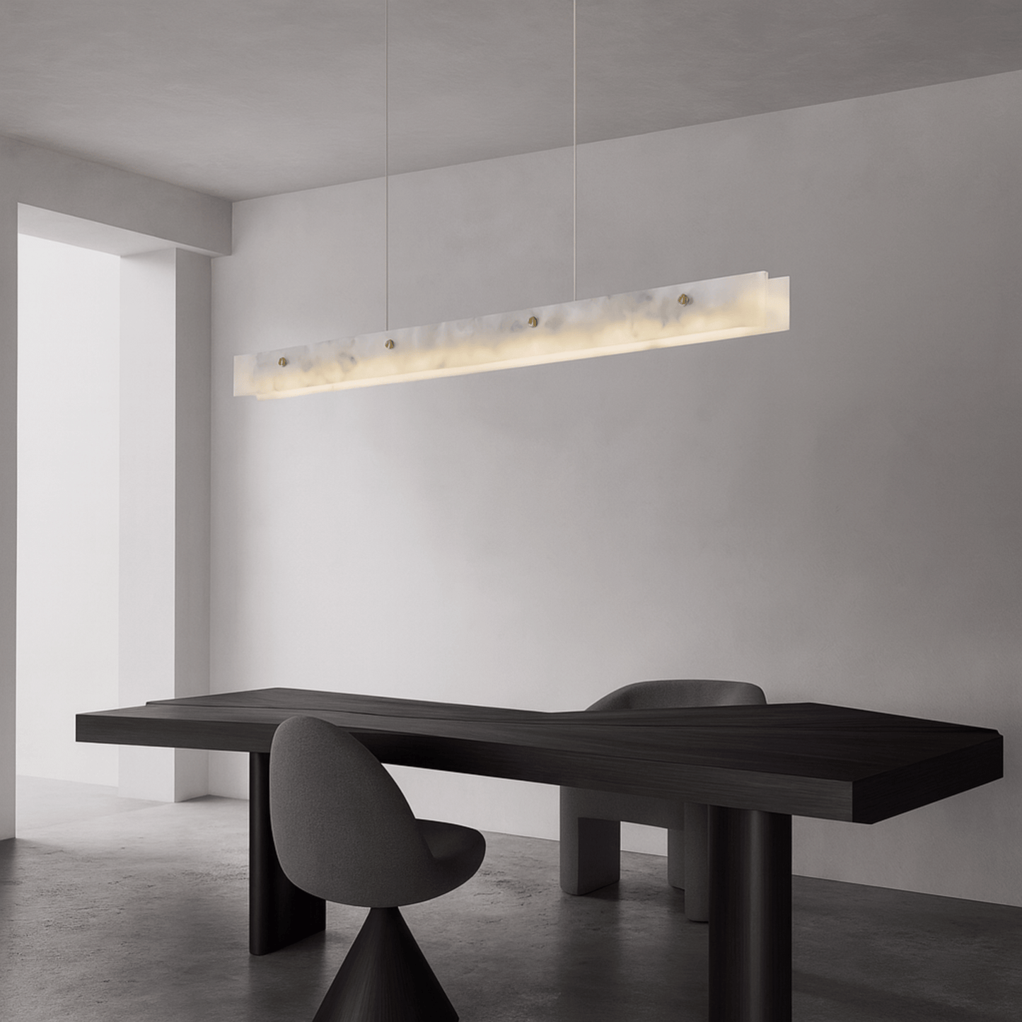Modern black dining table with chairs in a minimalistic room with a pendant light.