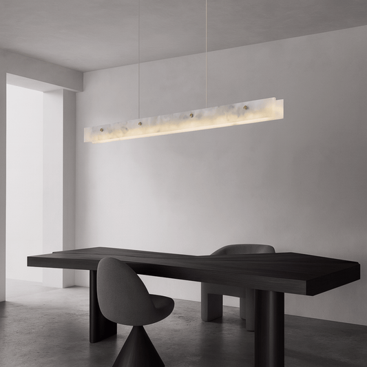 Modern black dining table with chairs in a minimalistic room with a pendant light.
