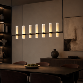 Modern chandelier in a dining room setting with a neutral color palette.