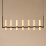 Modern pendant light with multiple cylindrical lights on a beige background