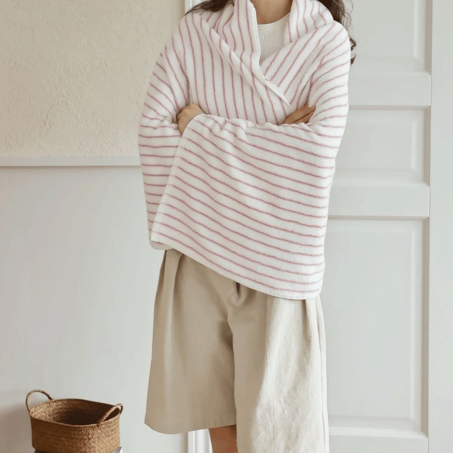 Someone wrapped in a pink and white bath towel 