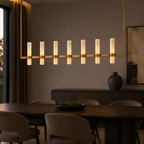 Modern dining room with a long linear chandelier, wooden table, and chairs.
