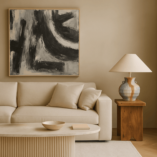 Modern living room with beige sofa, abstract painting, and wooden side table.