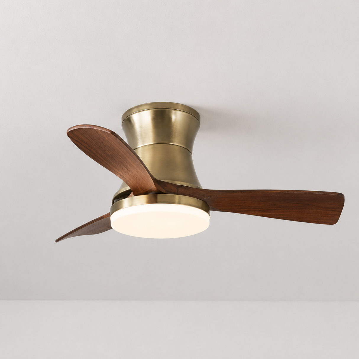 Ceiling fan with brass finish and wooden blades on a white background