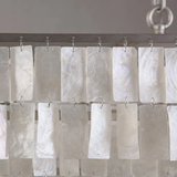 Shower curtain with white rectangular panels on a metal rod