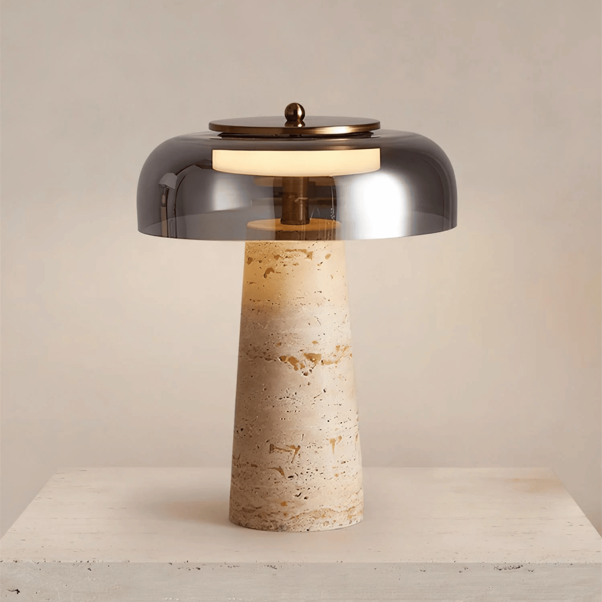Table lamp with smoked glass shade and textured base on a neutral background
