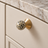 Solvi Brass Ball Cabinet Knobs – Spotted – Close-up installed on cream cabinetry