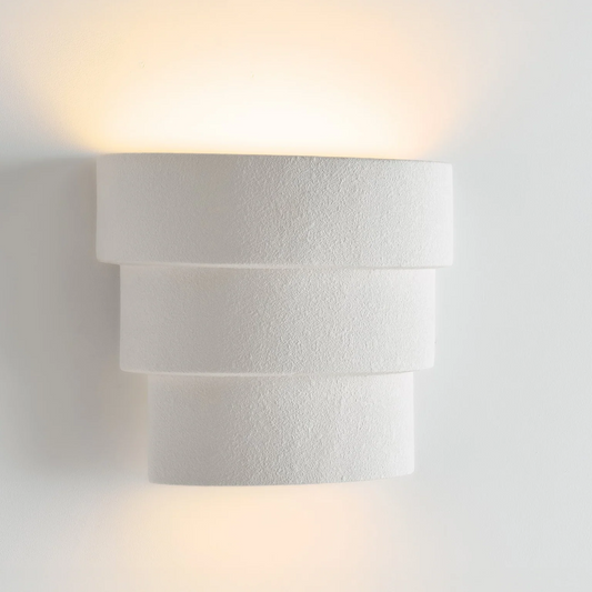 Modern wall-mounted light fixture on a white wall