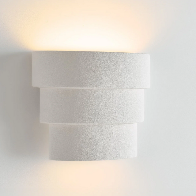 Modern wall-mounted light fixture on a white wall