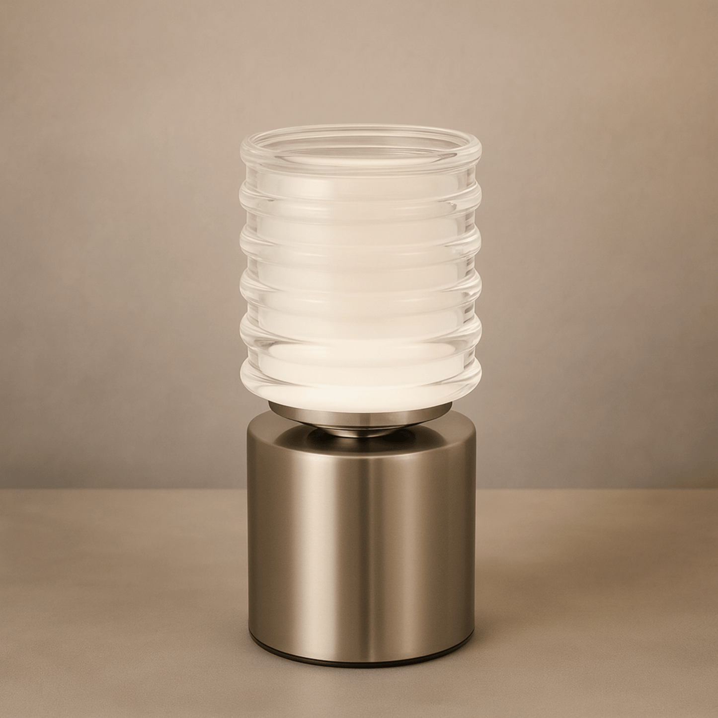 Table lamp with ribbed glass shade and metallic base on a beige background