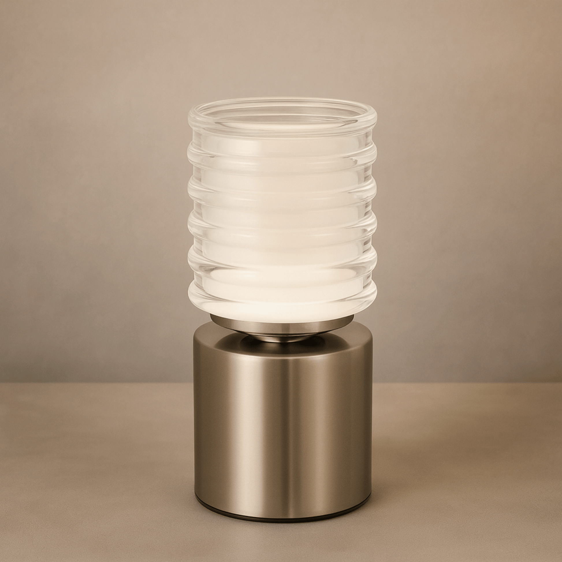 Table lamp with ribbed glass shade and metallic base on a beige background