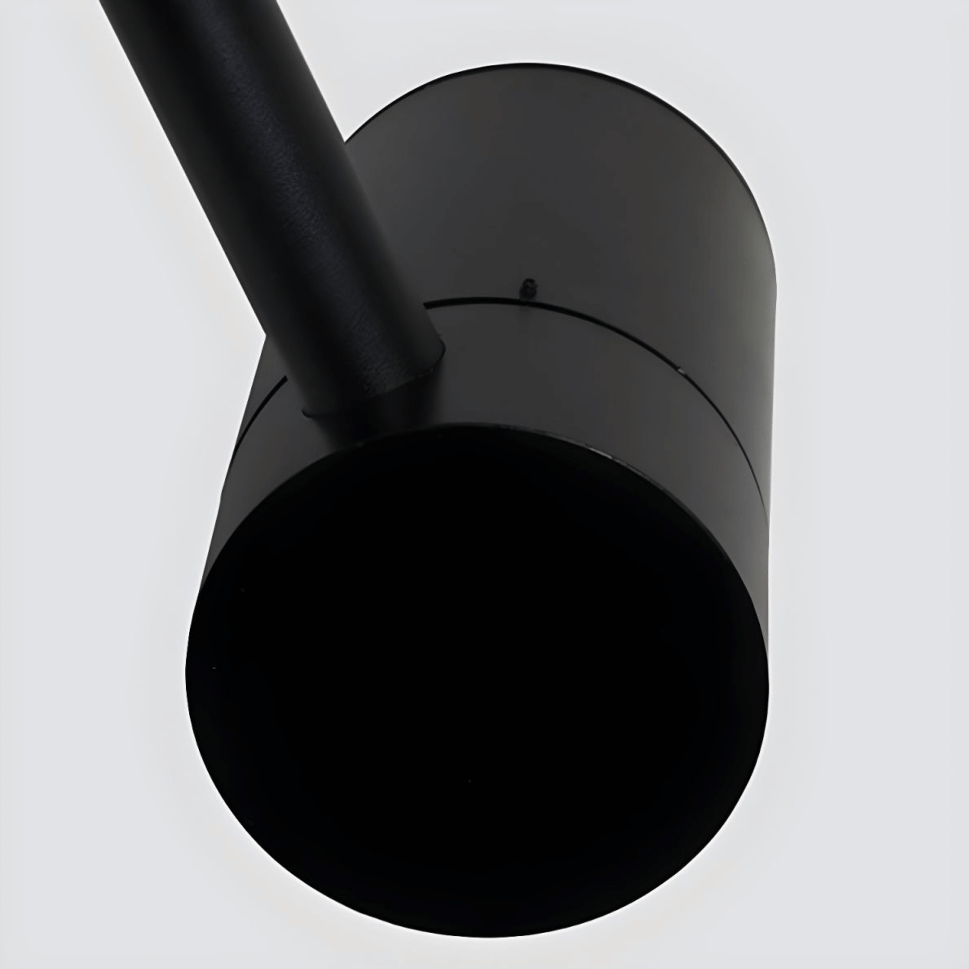 Black cylindrical object on a white background
