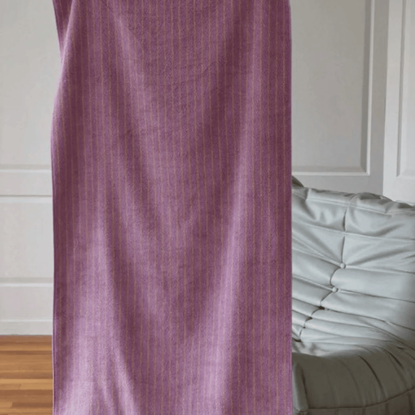 Purple curtain partially covering a bed with white bedding in a room.