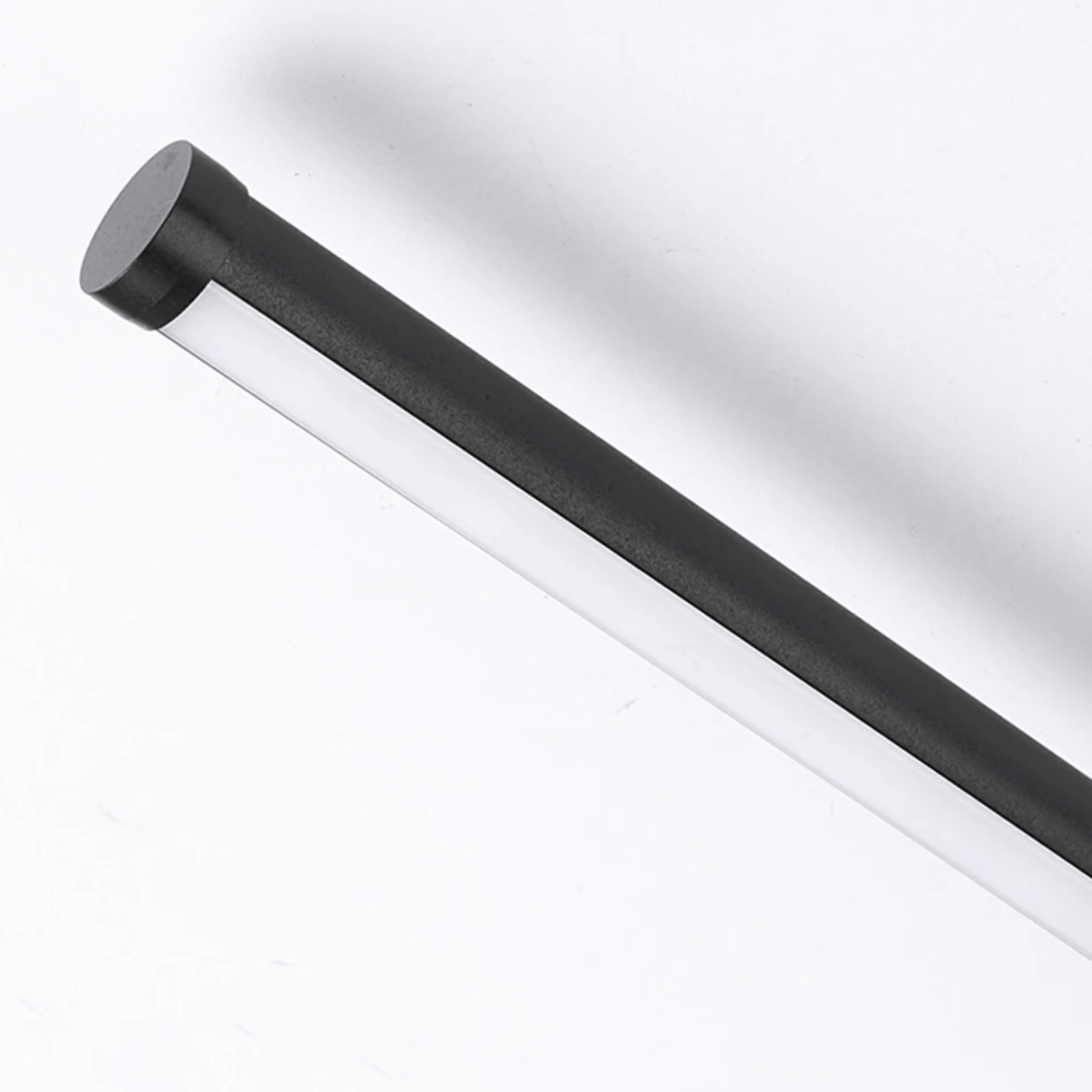 Black cylindrical object on a white background