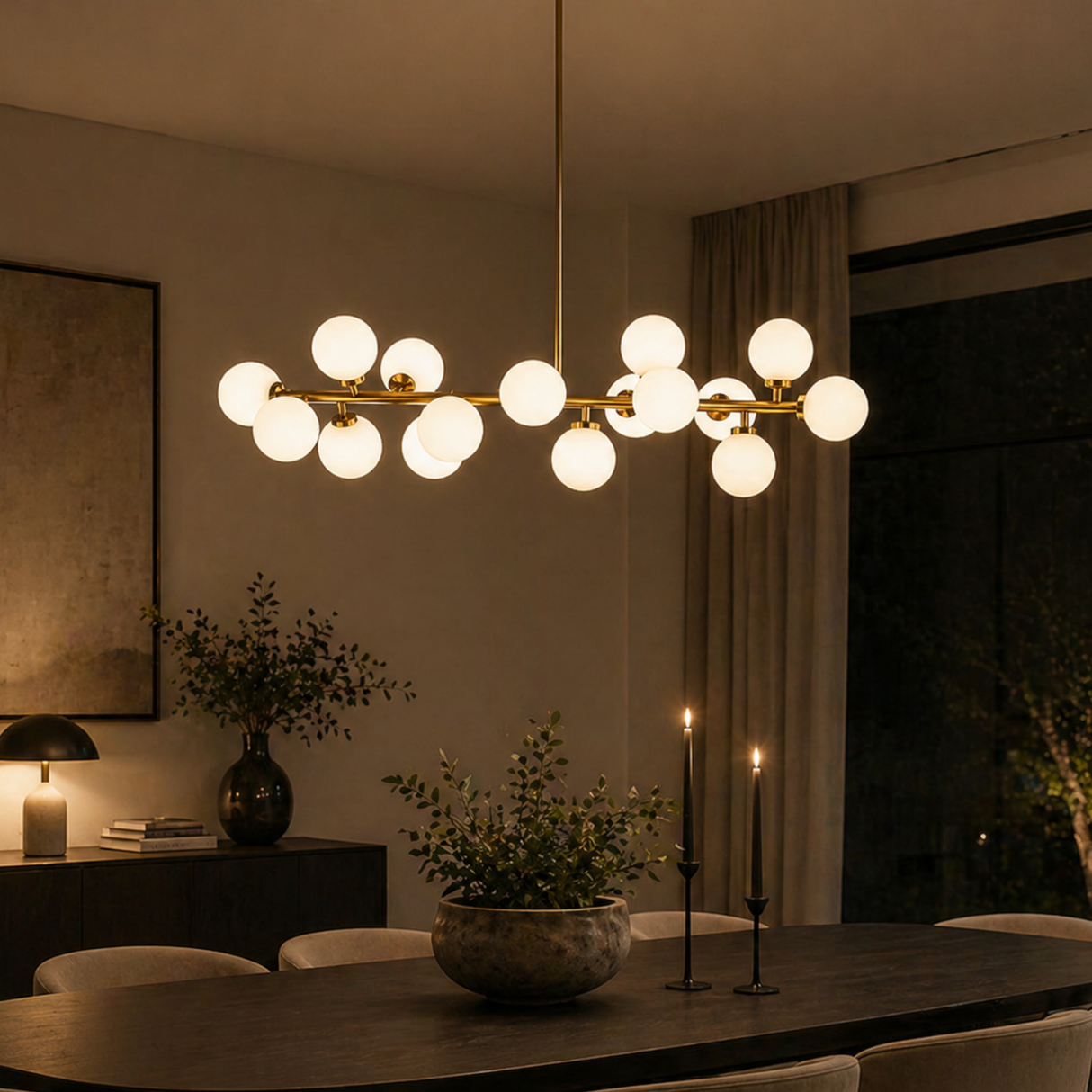 Modern chandelier hanging above a dining table in a dimly lit room.