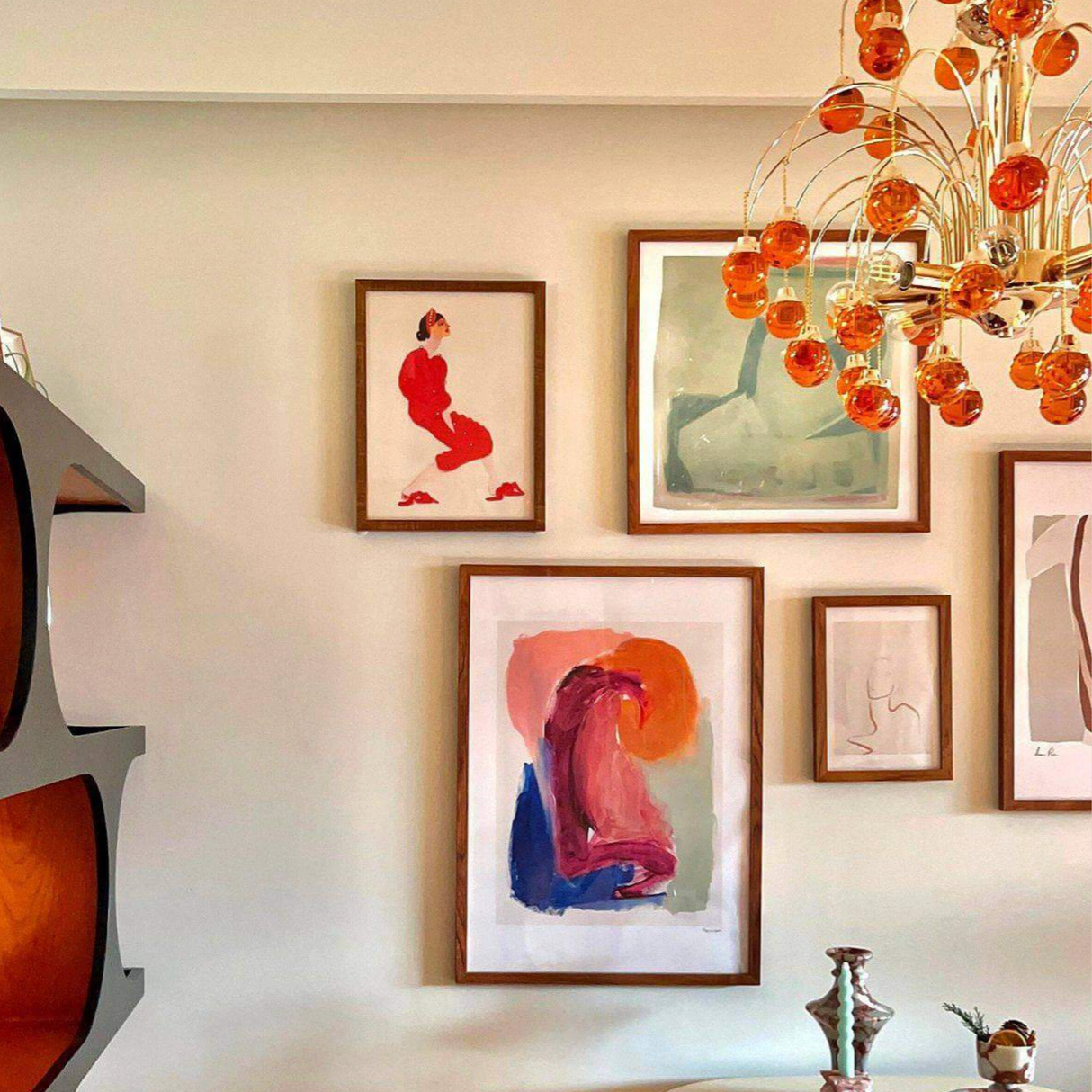Living room with abstract art on the wall and a modern chandelier.