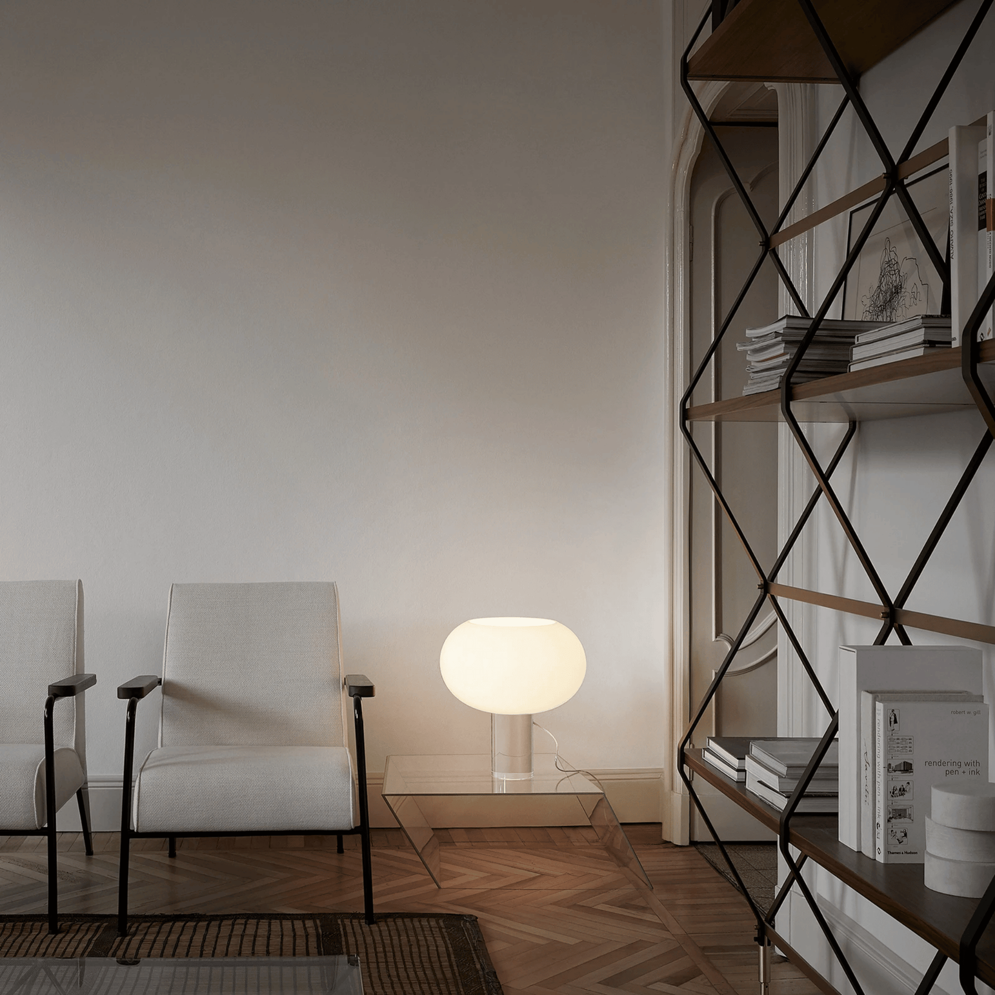 Modern living room with white armchair, glass coffee table, and geometric shelf.