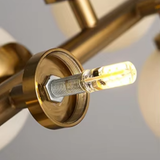 Close-up of a gold light fixture with a blurred background