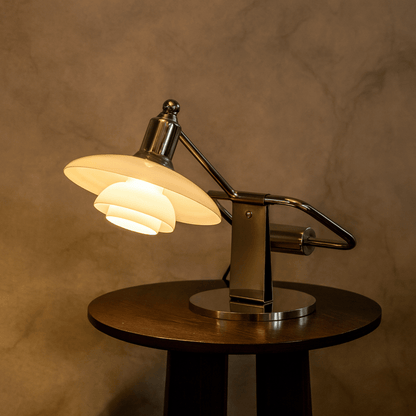 Vintage-style desk lamp with a warm glow on a wooden base against a brown background