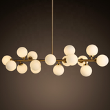 Modern chandelier with multiple round glass shades on a dark background