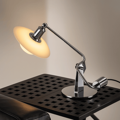 Modern desk lamp with adjustable arm on a black surface